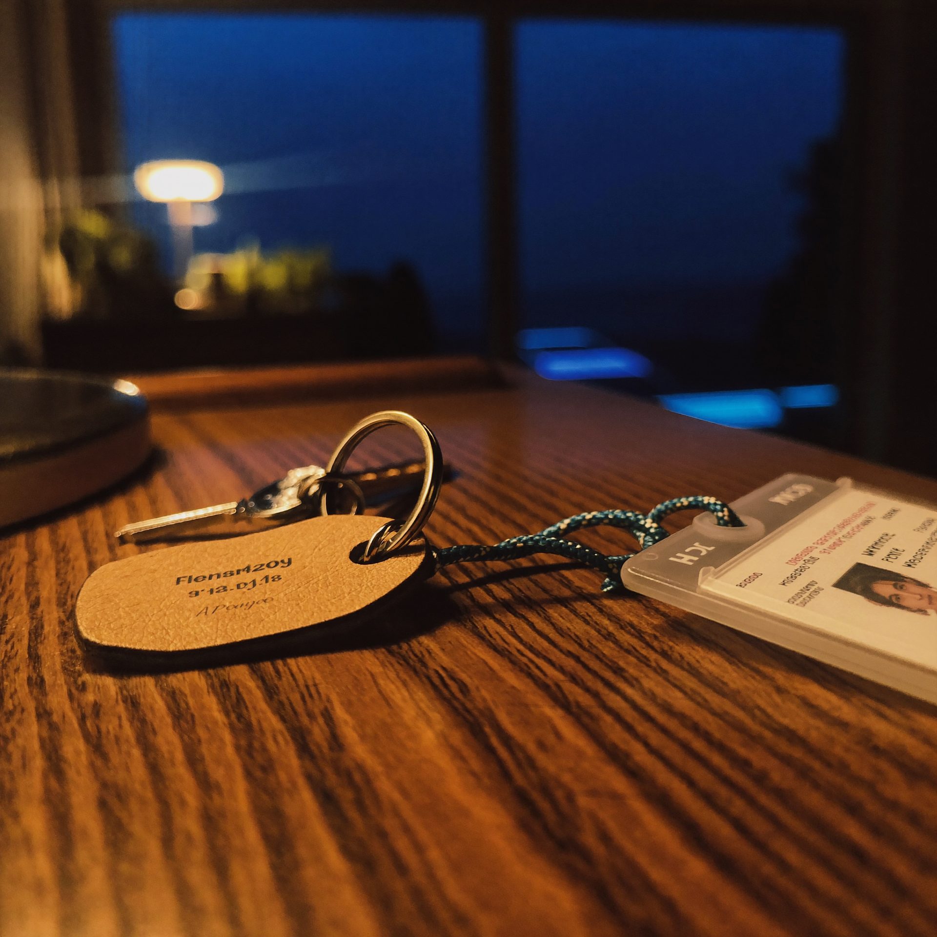 House keys beside a hospital badge on an entry table